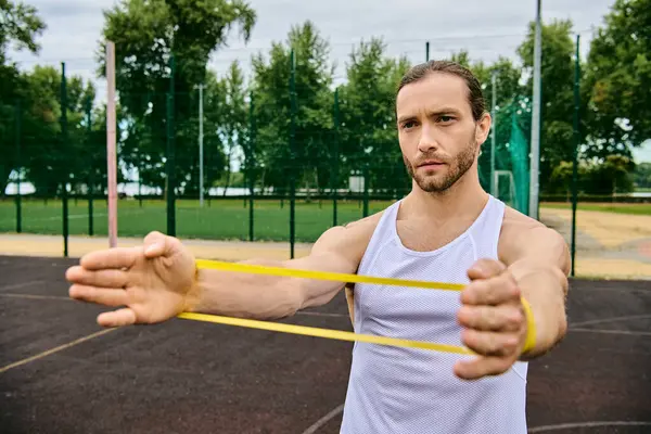 A determined man in sportswear during resistance band training — Stock Photo