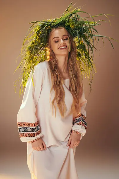 A young mavka in a white dress adorned with a plant crown in a fairy and fantasy studio setting. — Stock Photo