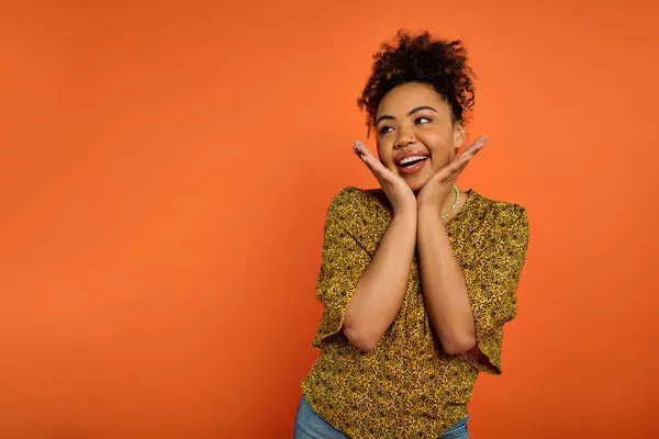 African American woman in stylish attire, hands on face, expressing deep emotion. — Stock Photo