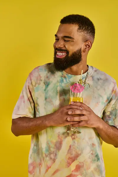 Un hombre con una barba exuberante sostiene una delicada flor en su mano, mostrando una armoniosa mezcla de masculinidad y naturaleza. - foto de stock