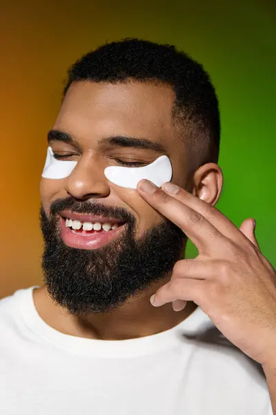 African american stylish man using eye patches. — Stock Photo