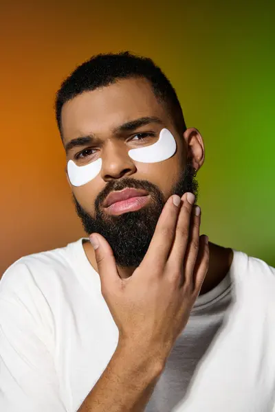 Handsome young man with eye patches on his face. — Stock Photo
