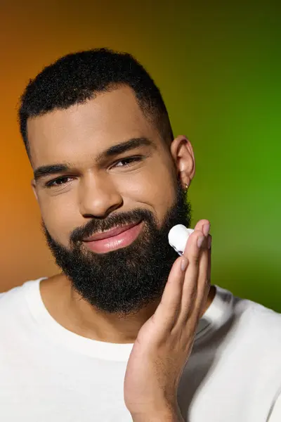 African american stylish man holds shaving cream. — Stock Photo