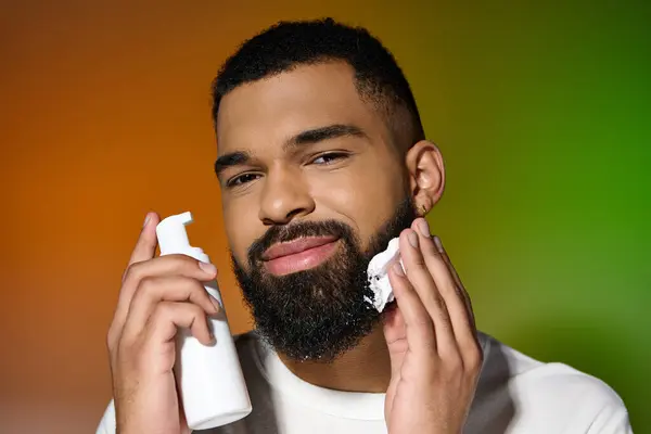 Afroamericano gioioso uomo utilizzando la crema da barba. — Foto stock