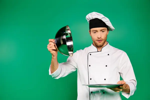 A man in a white uniform holding a platter. — Stock Photo