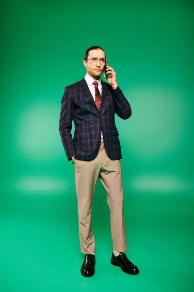 A handsome businessman in a chic suit engaged in a phone conversation. — Stock Photo