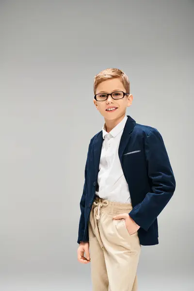 Preadolescent boy in stylish suit and glasses, exuding confidence and sophistication. — Stock Photo