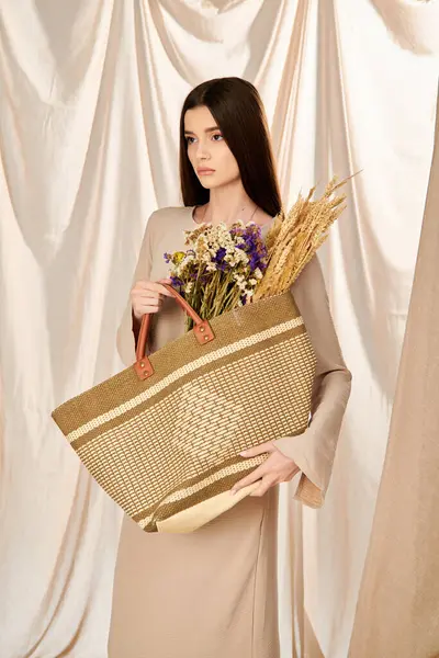 A young woman with long brunette hair joyfully holds a basket overflowing with vibrant flowers, embodying a summer mood. — Stock Photo