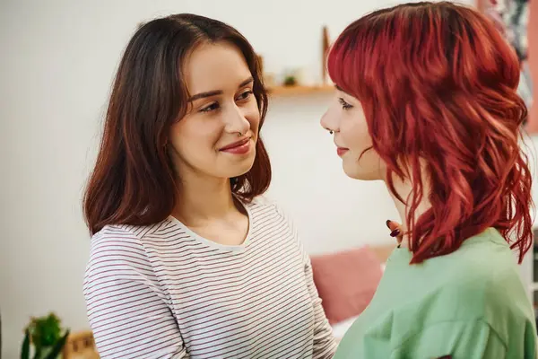 Portrait of young and happy lesbian woman looking at her female partner with red hair at home — Stock Photo