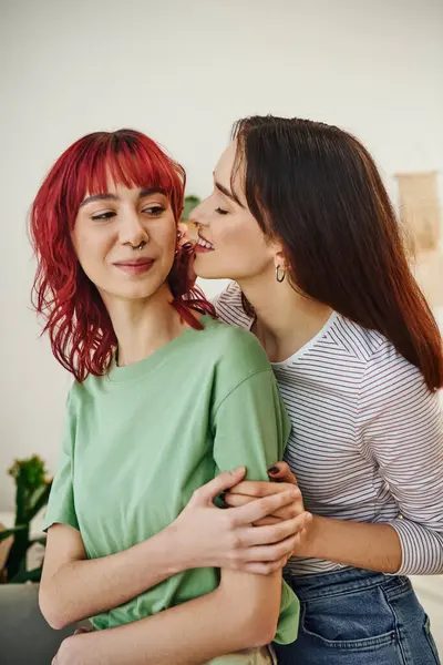 Portrait of young and smiling lesbian woman looking at her female partner with red hair at home — Stock Photo