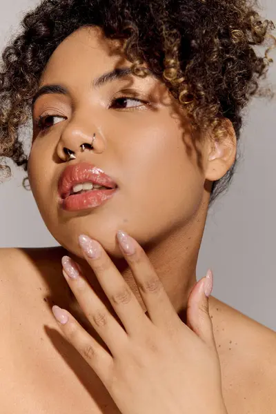 Nahaufnahme einer schönen afroamerikanischen Frau mit lockigem Haar, die Eleganz und Selbstbewusstsein in einem Studio-Setting ausstrahlt. — Stockfoto