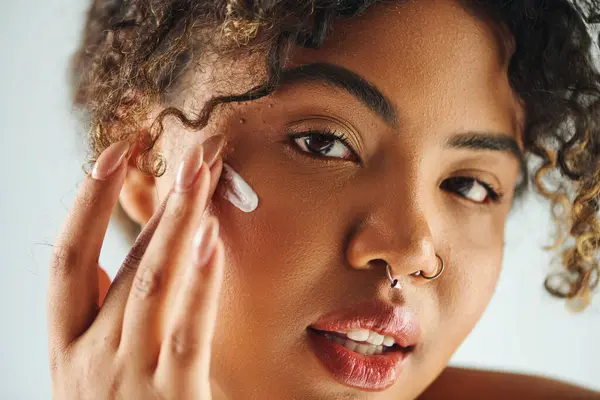 Close-up de mulher afro-americana delicadamente tocando seu rosto. — Fotografia de Stock