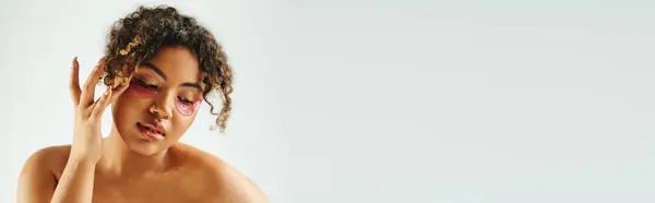 Appealing African American woman showcasing eye patches on a vibrant backdrop. — Stock Photo