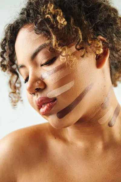 African American woman with foundation on face poses against vibrant backdrop. — Stock Photo