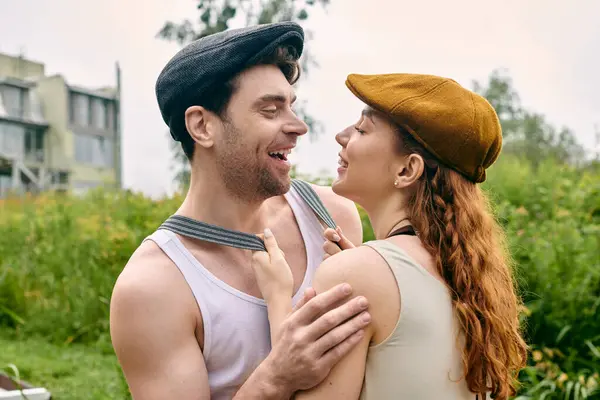 A man and a woman stand closely beside each other in a serene green park, embodying love and connection. — Stock Photo