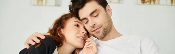 A man and a woman standing close, sharing a moment of intimacy and connection in a bedroom setting. — Stock Photo