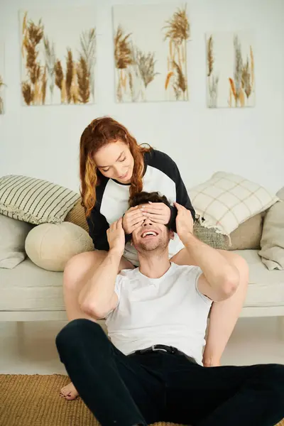 A man and woman sitting comfortably in a cozy bedroom, engaged in a deep conversation. — Stock Photo