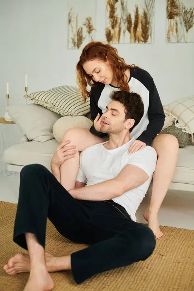 A man peacefully sits with woman, both enjoying a moment of relaxation in a cozy living room setting. — Stock Photo