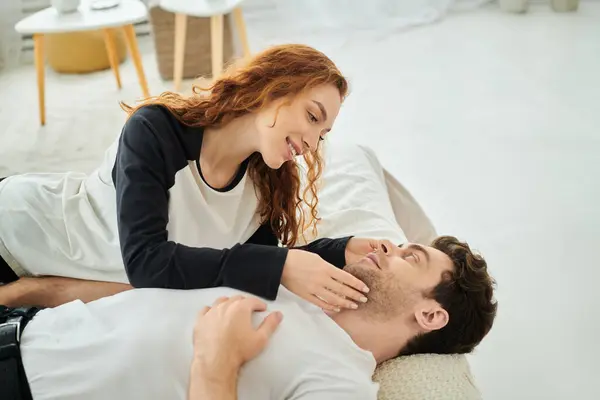 A man and a woman, deeply in love, lay intertwined on a cozy bed, enjoying a peaceful moment together. — Stock Photo