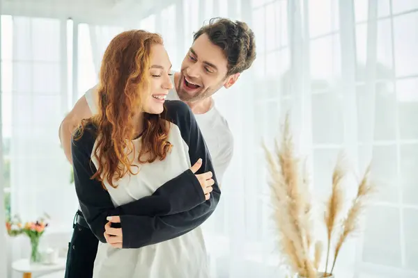 A man tenderly holds a woman in his arms in a warm and intimate moment of connection and affection. — Stock Photo