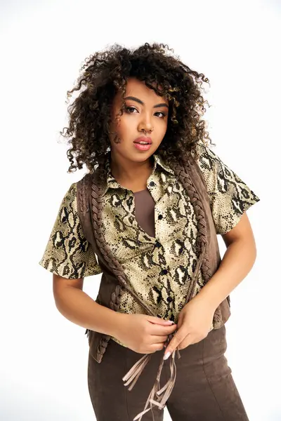 Elegant african american fashionista in trendy outfit with animalistic print looking at camera — Stock Photo