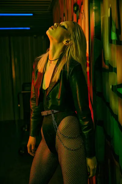 A woman wearing a leather jacket and fishnet stockings — Stock Photo