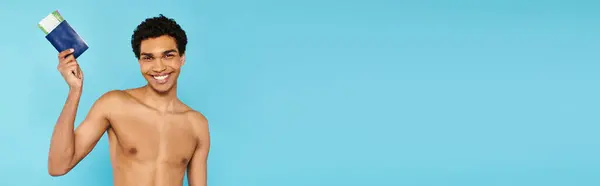 Merry african american man with passport and ticket on blue background looking at camera, banner — Stock Photo
