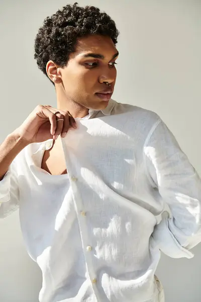 Appealing african american male model in linen sophisticated attire posing on beige backdrop — Stock Photo