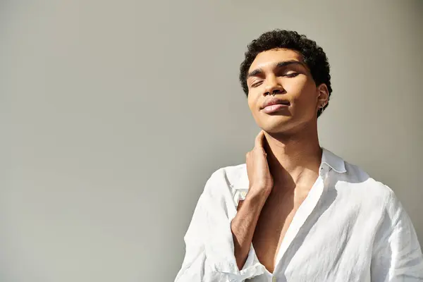 Alluring african american male model in linen sophisticated attire posing on beige backdrop — Stock Photo