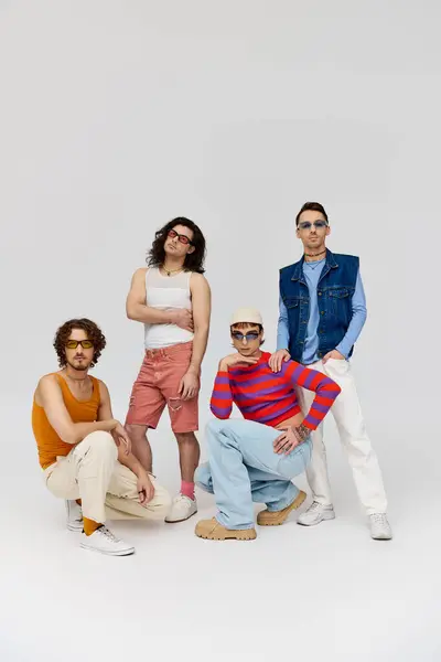 Four attractive cheerful gay friends with stylish sunglasses posing actively together, pride month — Stock Photo
