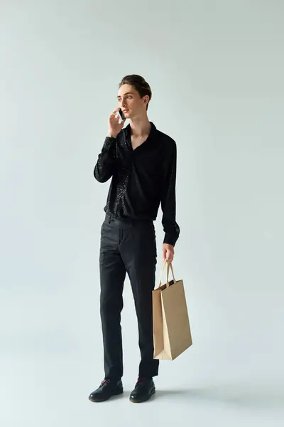 A queer person holds shopping bag, talks on phone. LGBT, pride. — Stock Photo