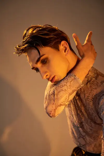 A fashionable young man strikes a pose, showcasing his unique style and confident demeanor. — Stock Photo