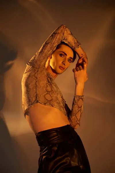 A young queer person confidently poses in a leather skirt, exuding elegance and pride in her stylish attire. — Stock Photo