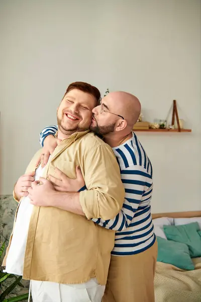 Two men affectionately hug in cozy living room. — Stock Photo