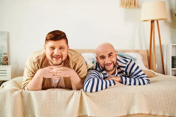 A gay couple enjoying a peaceful moment while laying on a bed. — Stock Photo