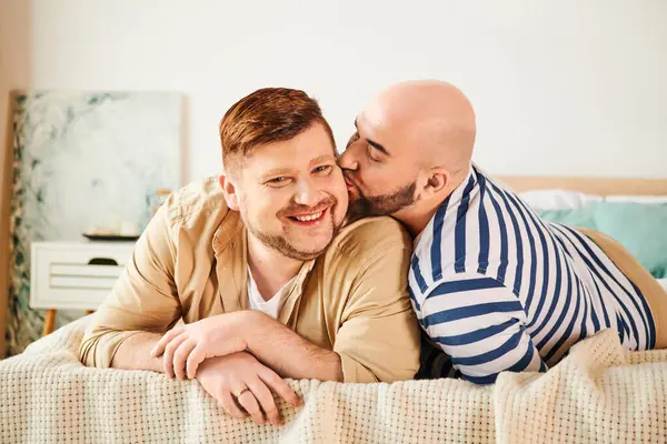 Two men relaxing on bed together at home. — Stock Photo
