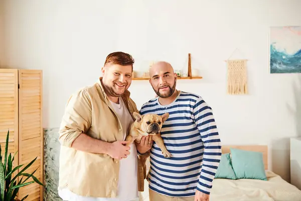 Gay couple standing together, holding their French Bulldog. — Stock Photo