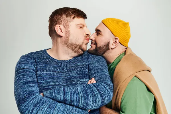 Two men stand closely together, embracing the bond between them. — Stock Photo