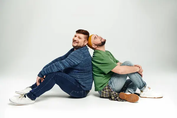 Two men sit closely, showcasing love and companionship. — Stock Photo
