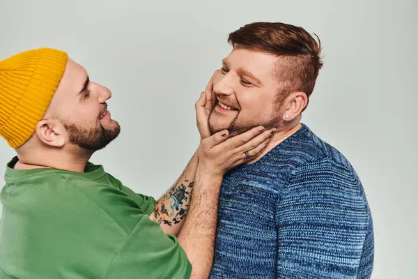 Dos hombres de pie uno al lado del otro y mirándose. - foto de stock