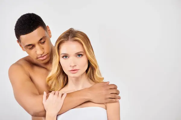 Man and woman share an intimate hug on a white background. — Stock Photo