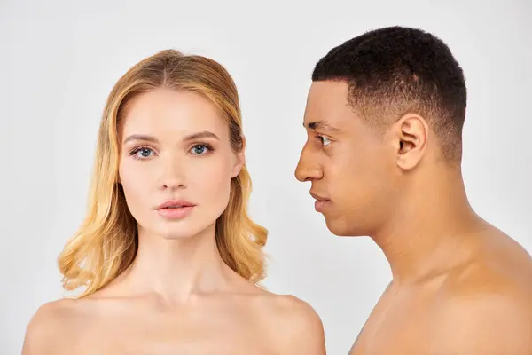 Trendy diverse couple sharing a moment, gazing lovingly at each other. — Stock Photo