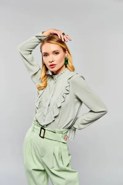 Woman wearing green blouse and pants posing for a portrait. — Stock Photo