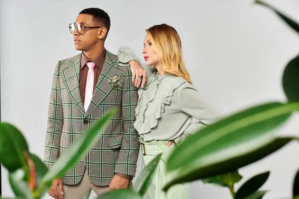 A man and woman romantically posing in front of vibrant plants. — Stock Photo