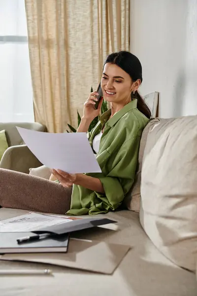 Casual woman working from home, engrossed in phone conversation. — Stock Photo