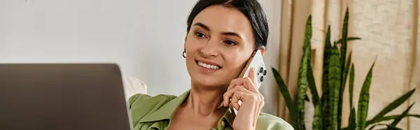 Woman in casual attire multitasking with cell phone and laptop. — Stock Photo