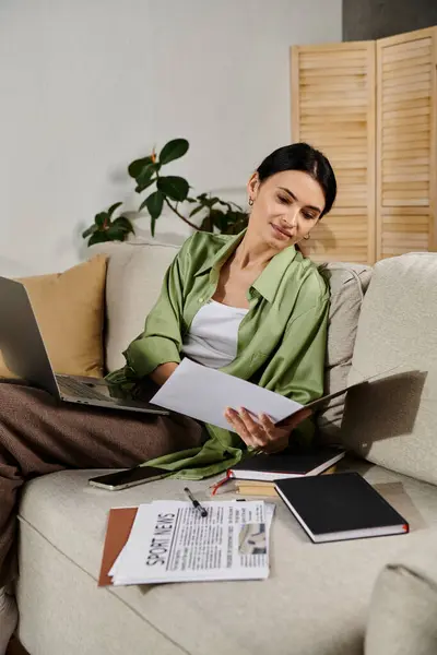 Woman in casual attire using laptop on couch. — Stock Photo