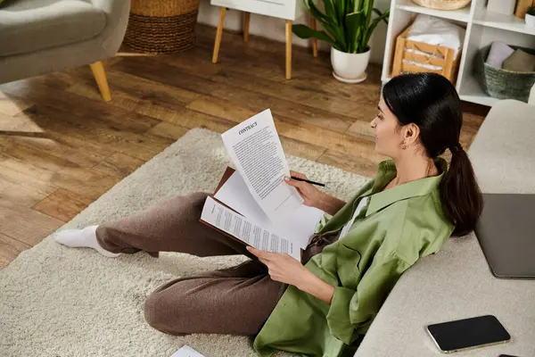 Casual woman engrossed in reading papers on floor. — Stock Photo