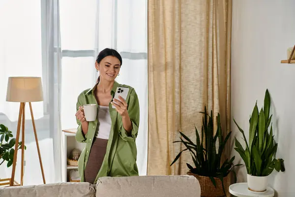 A woman in a living room, enjoying a cup of coffee. — Stock Photo