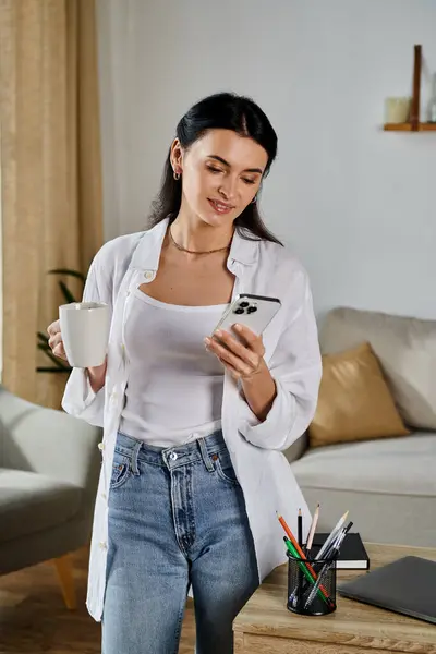 Casual woman engaged with smartphone in stylish living room. — Stock Photo